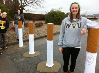 row of cloth cigarette “sleeves” slipped over 4-ft high concrete barriers